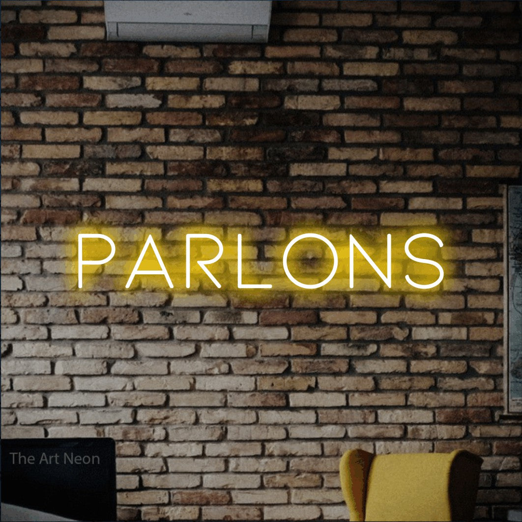 LED neon sign reading “PARLONS”, arranged in a single line.