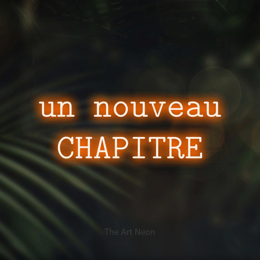 LED neon sign reading “un nouveau CHAPITRE”, arranged in 2 lines.