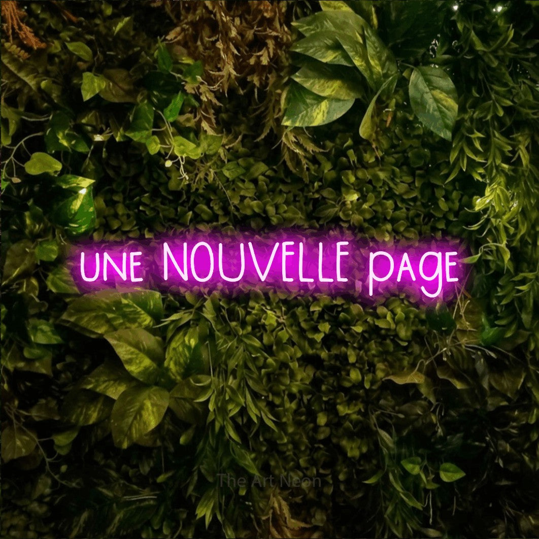 LED neon sign reading “une NOUVELLE page”, arranged in a single line.