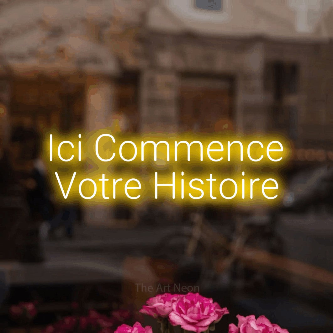 LED neon sign reading “Ici Commence Votre Histoire”, arranged in 2 lines.