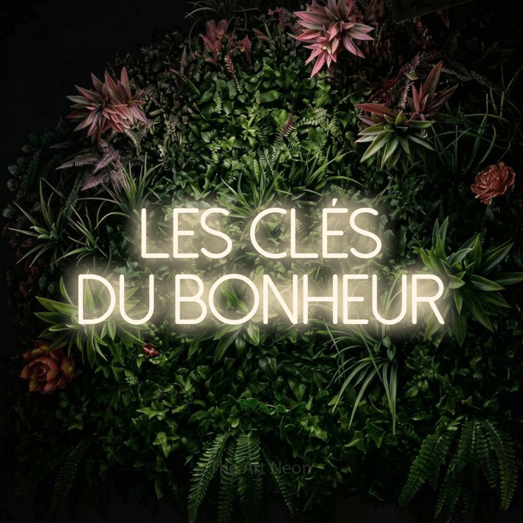LED neon sign reading “les clés du bonheur”, arranged in 2 lines.