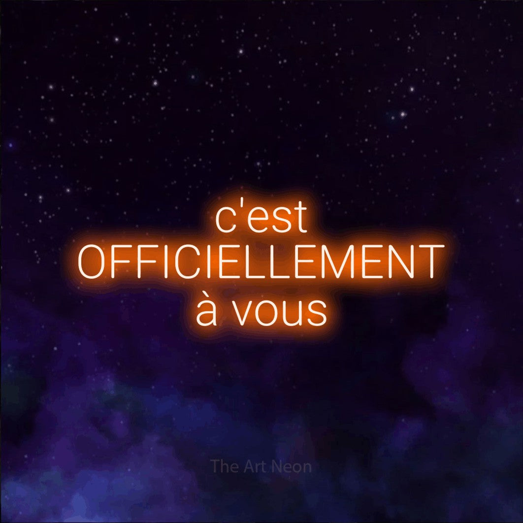 LED neon sign reading “c'est OFFICIELLEMENT à vous”, arranged in 3 lines.