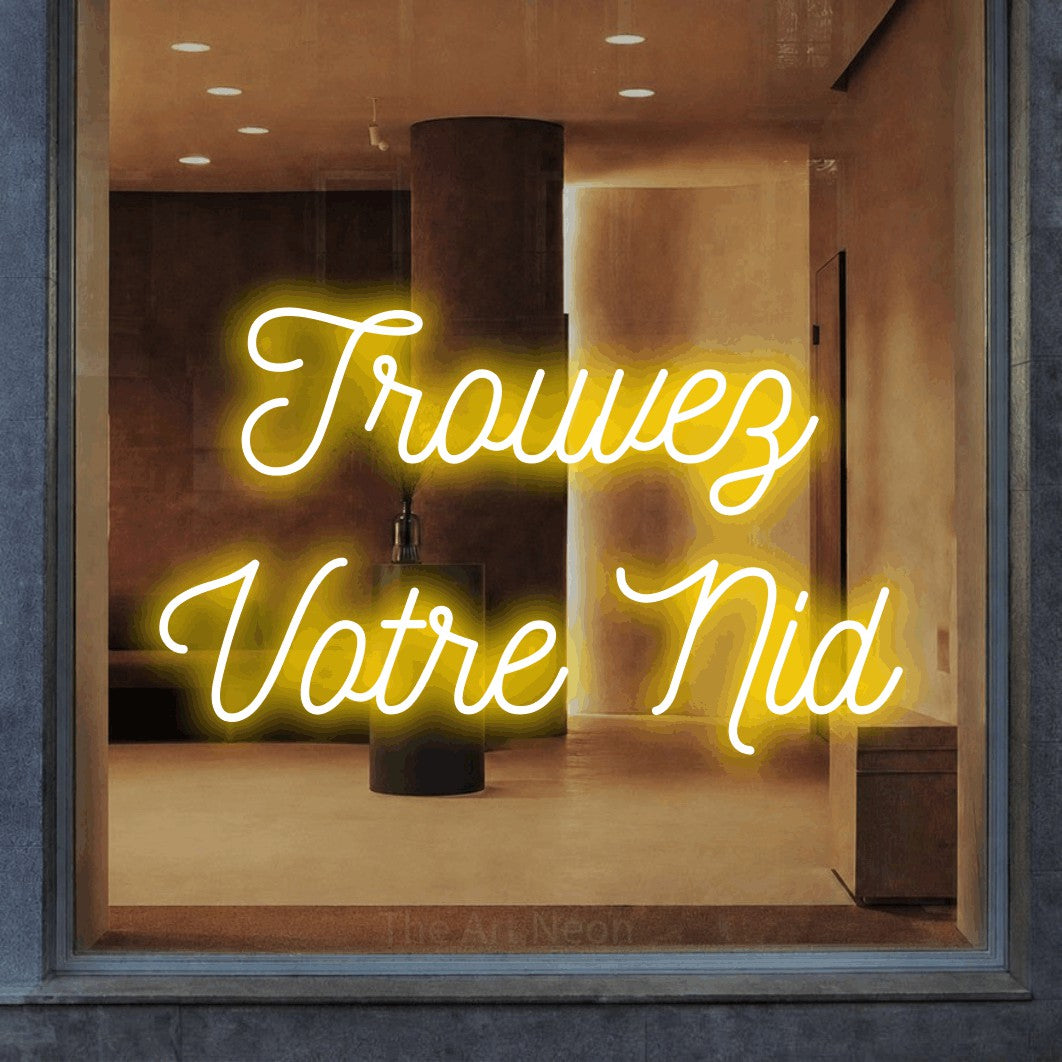 LED neon sign reading “Trouvez Votre Nid”, arranged in 2 lines.