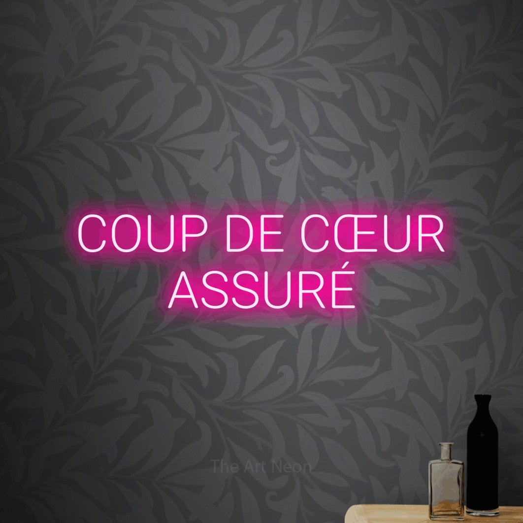LED neon sign reading “COUP DE CŒUR ASSURÉ”, arranged in 2 lines.