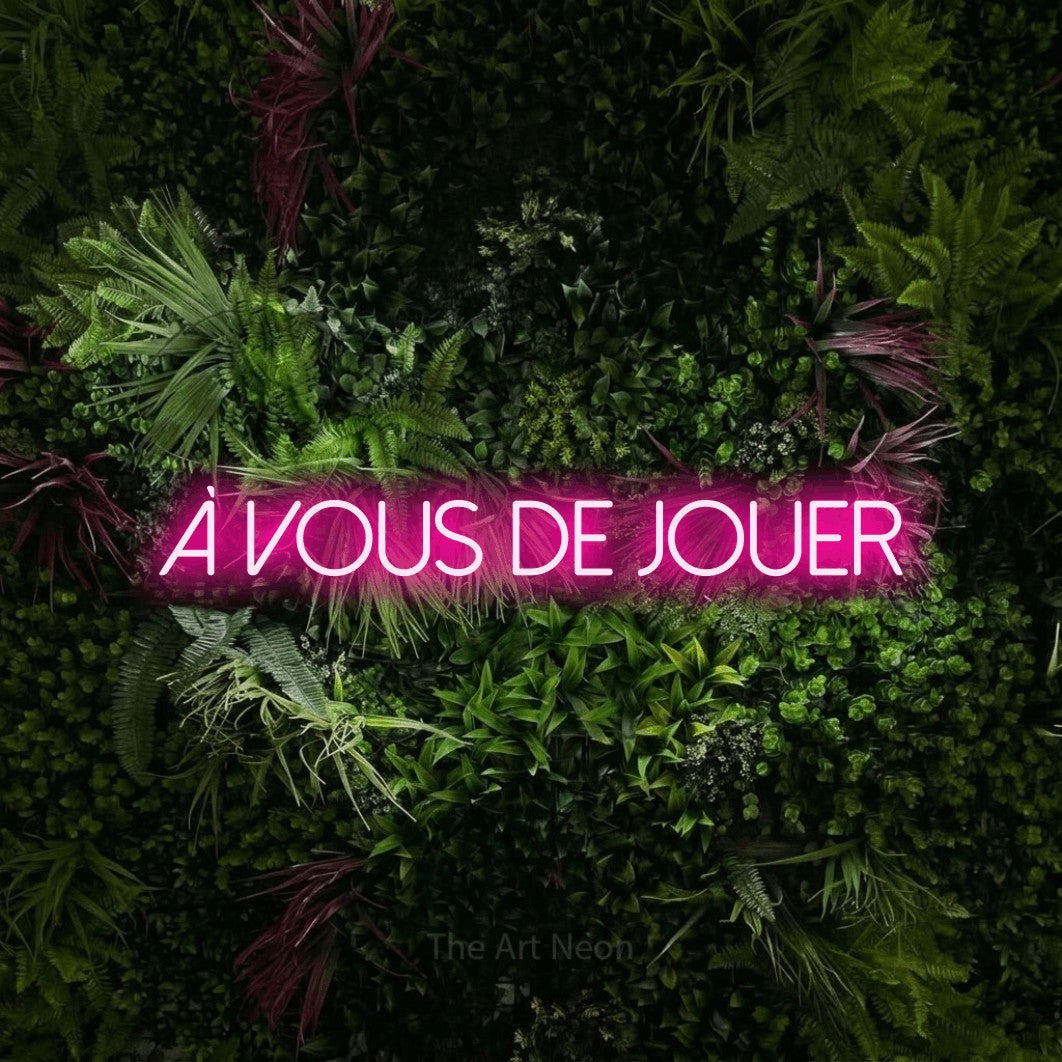 LED neon sign reading “à vous de JOUER”, arranged in a single line.
