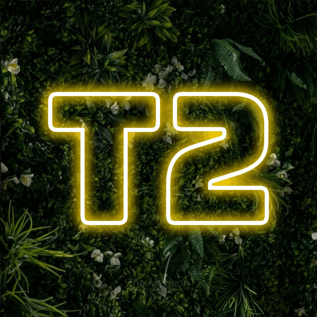 LED neon sign reading “T2”, arranged in a single line.