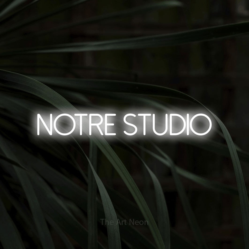 LED neon sign reading “NOTRE STUDIO”, arranged in a single line.