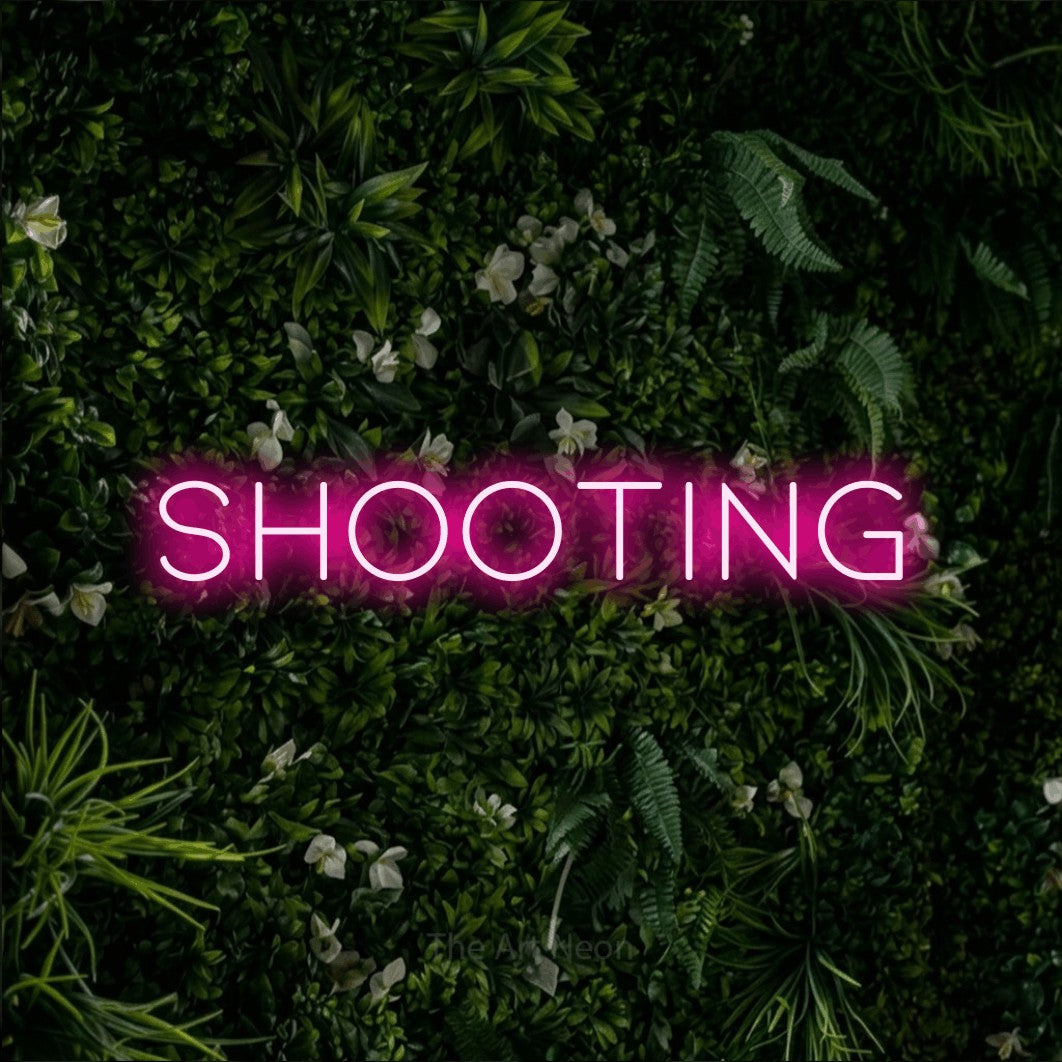 LED neon sign reading “SHOOTING”, arranged in a single line.
