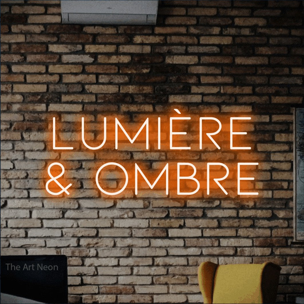 LED neon sign reading “LUMIÈRE & OMBRE”, arranged in 2 lines.