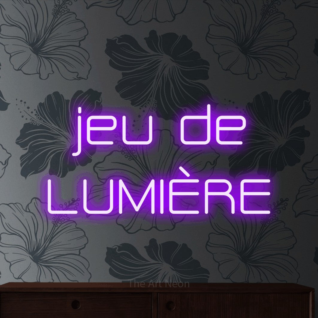 LED neon sign reading “jeu de LUMIÈRE”, arranged in 2 lines.