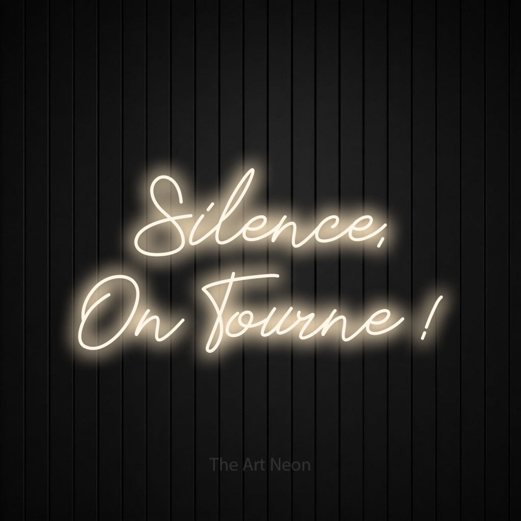 LED neon sign reading “Silence, On Tourne !”, arranged in 2 lines.