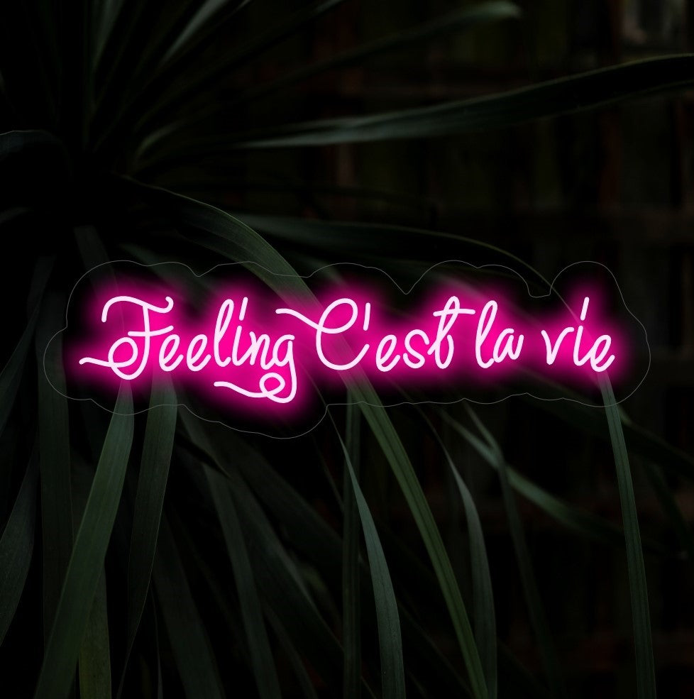 "Feeling C'est La Vie Neon Sign" lights up with a carefree glow, ideal for spaces that embrace the playful attitude of living life to the fullest with a touch of French flair.