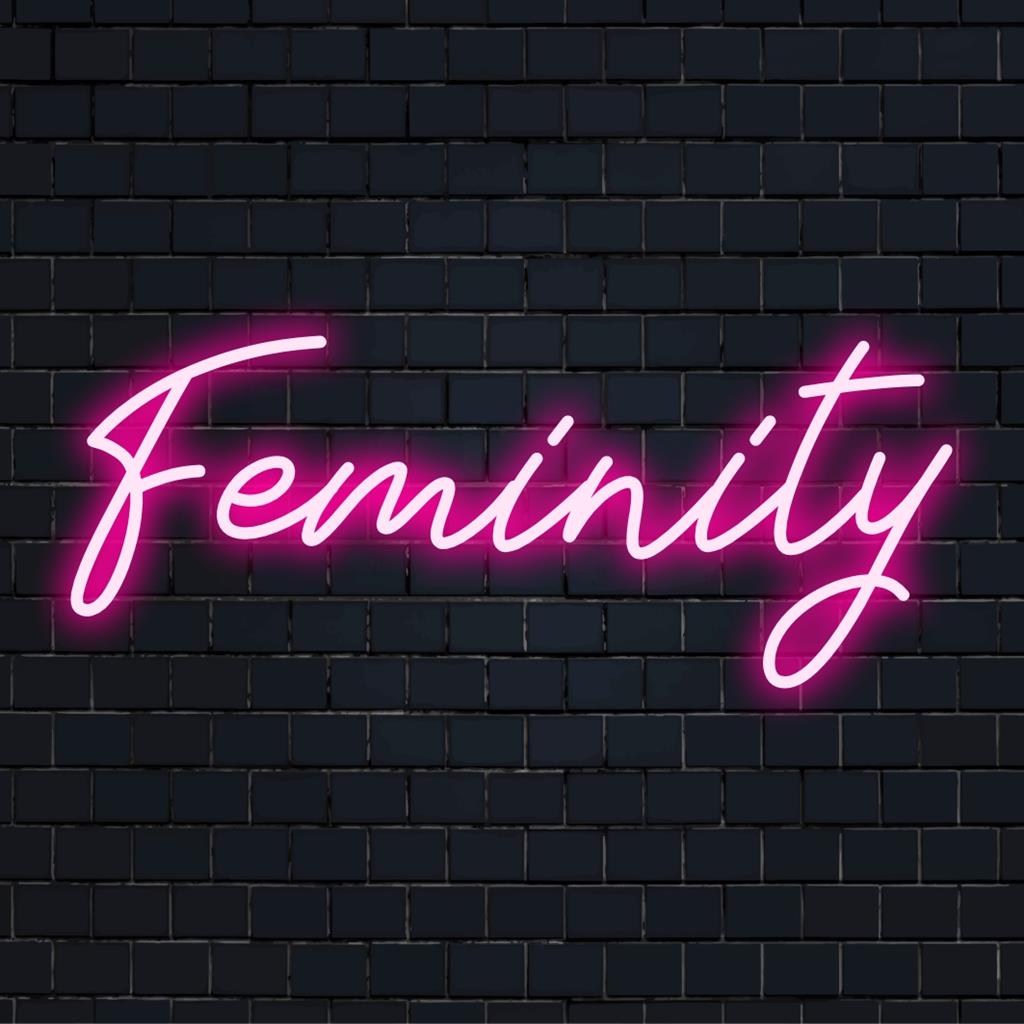 Custom LED neon sign titled Feminity, featuring elegant curves with vibrant pink tones, ideal for chic decor ambiance.