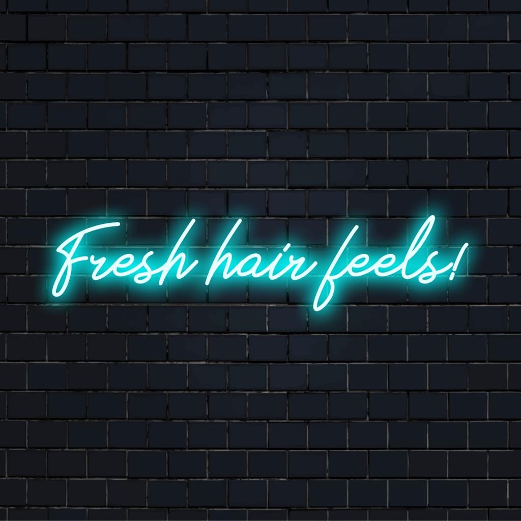 Custom LED neon sign displaying Fresh Hair Feels! in vibrant lights, perfect for salons or personal grooming spaces.