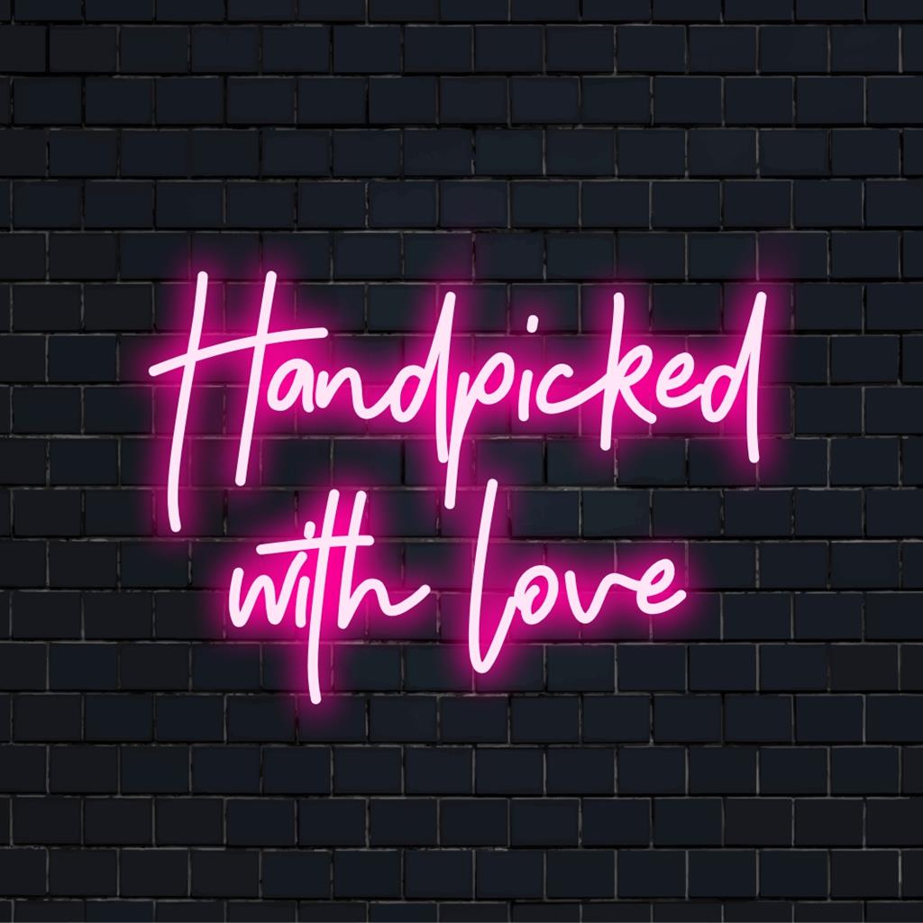 LED neon sign reading Handpicked With Love in curated artisan style, ideal for intimate spaces and bespoke wall decor.