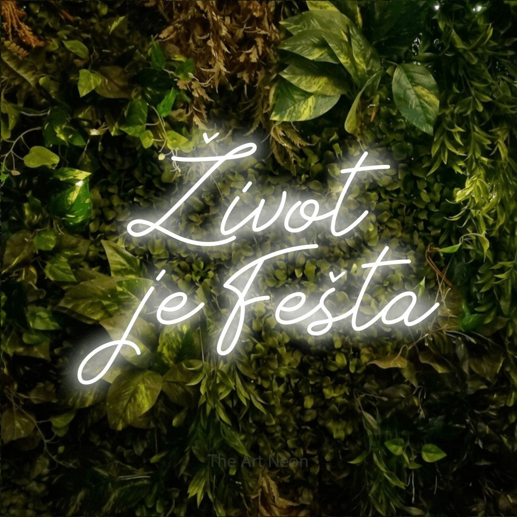 LED neon sign reading “Život je Fešta”, arranged in two lines.