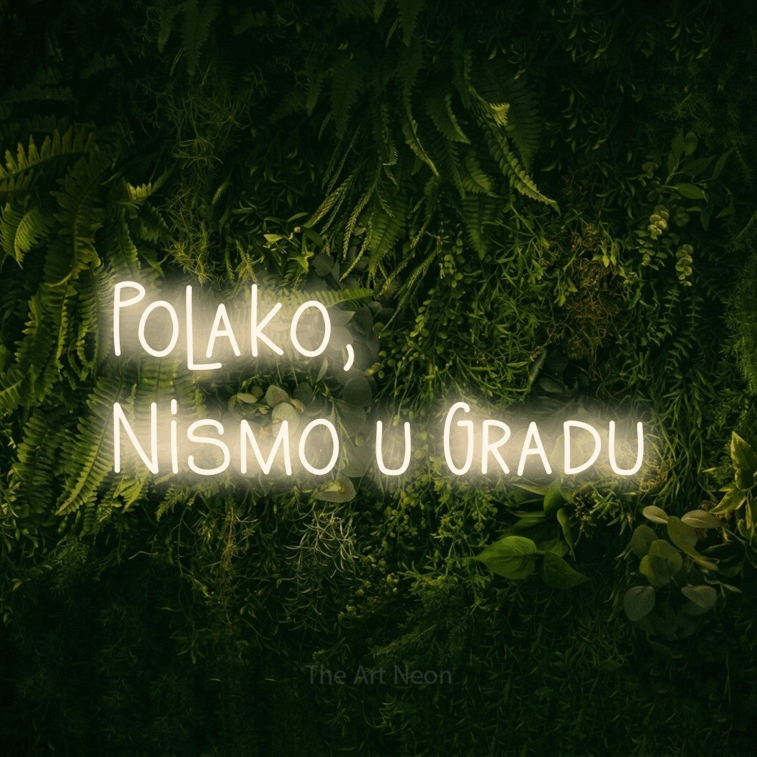 LED neon sign reading “Polako, Nismo u Gradu”, arranged in two lines.