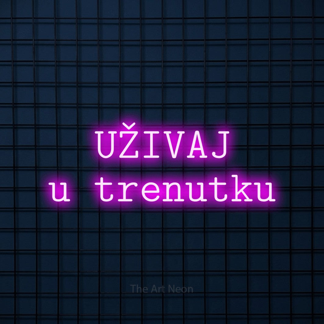 LED neon sign reading “UŽIVAJ u trenutku”, arranged in two lines.