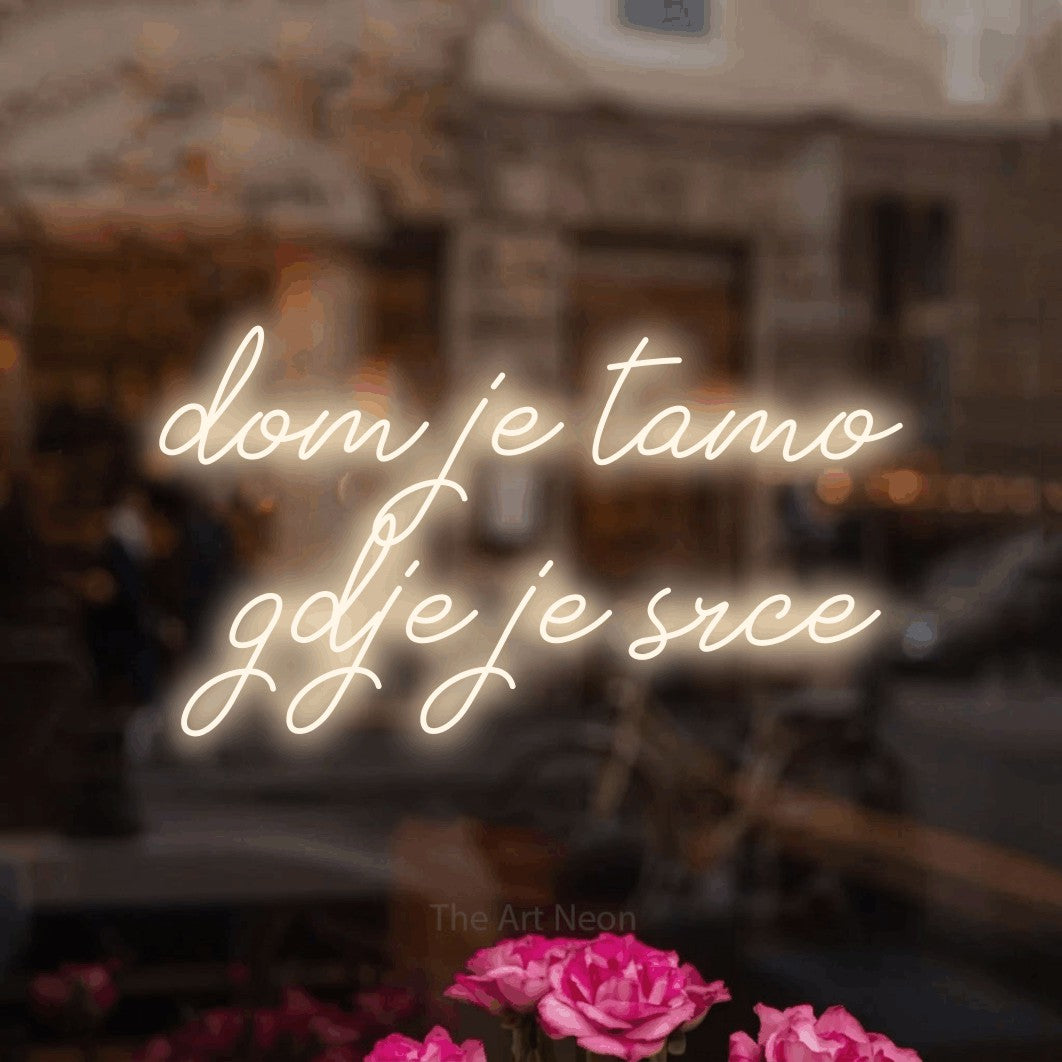LED neon sign reading “dom je tamo gdje je srce”, arranged in two lines.