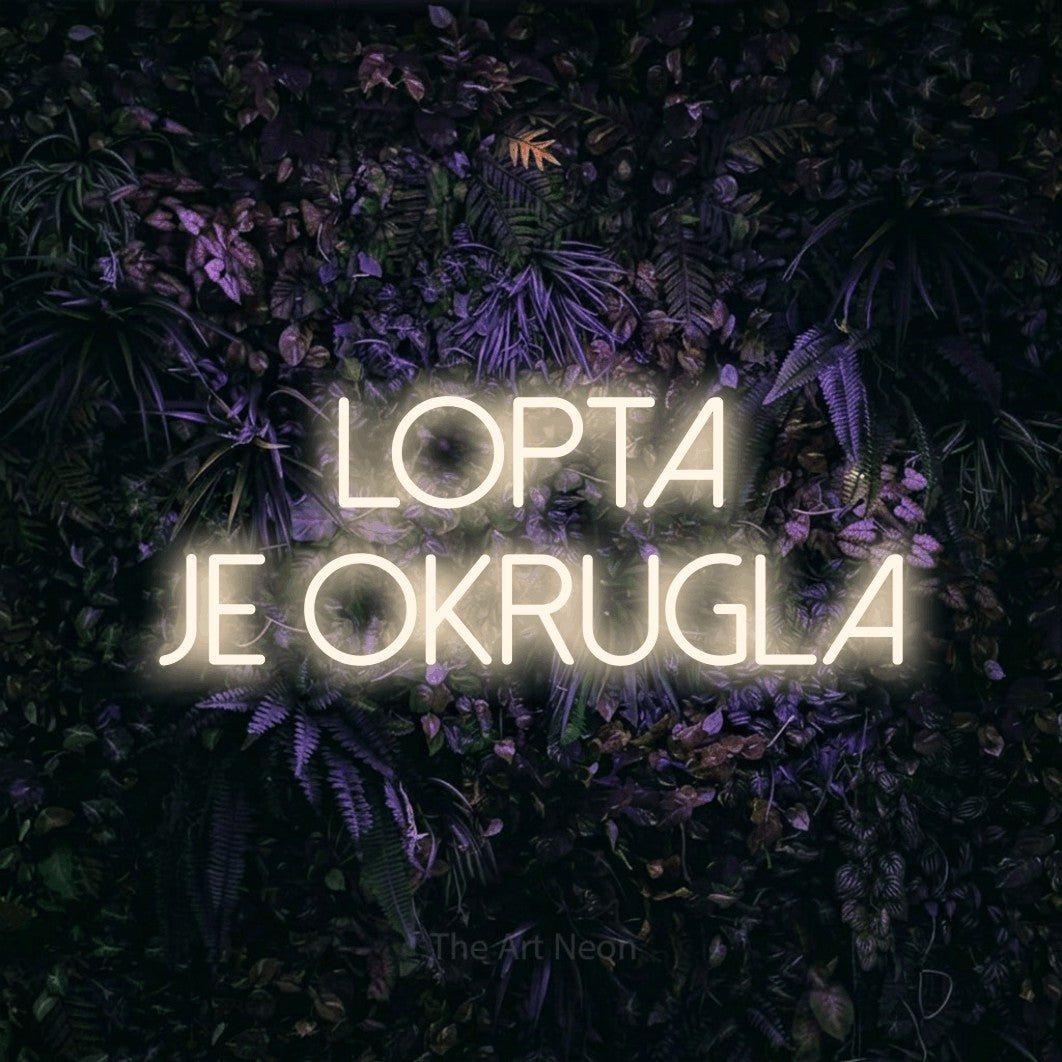 LED neon sign reading “lopta je okrugla”, arranged in two lines.