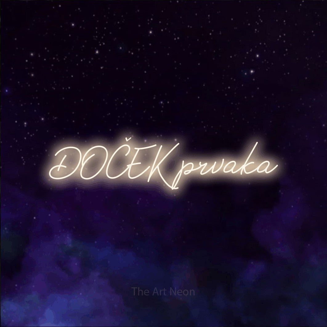 LED neon sign reading “DOČEK prvaka”, arranged in a single line.