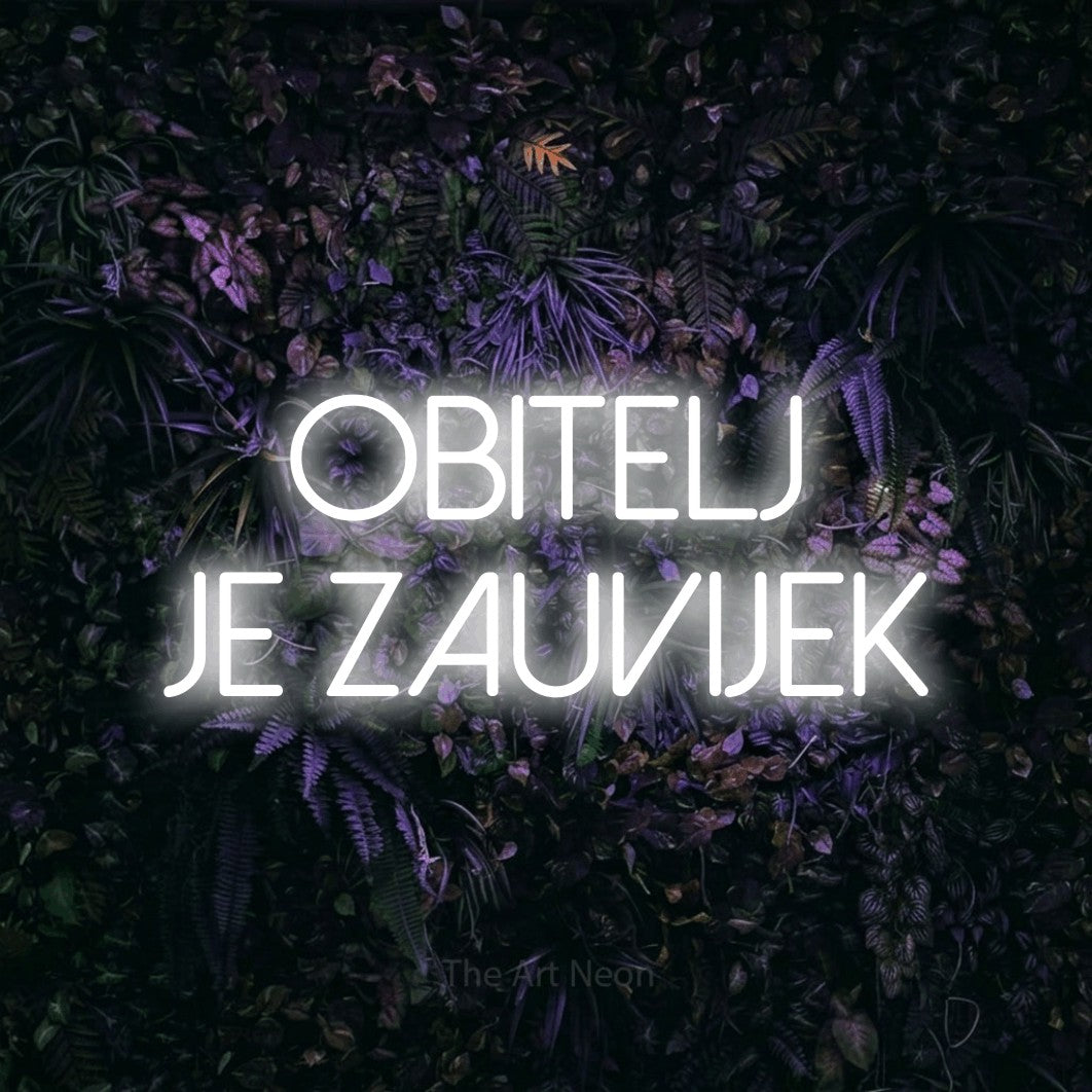 LED neon sign reading “OBITELJ JE ZAUVIJEK”, arranged in two lines.
