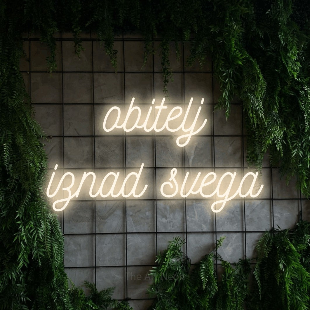 LED neon sign reading “obitelj iznad svega”, arranged in two lines.