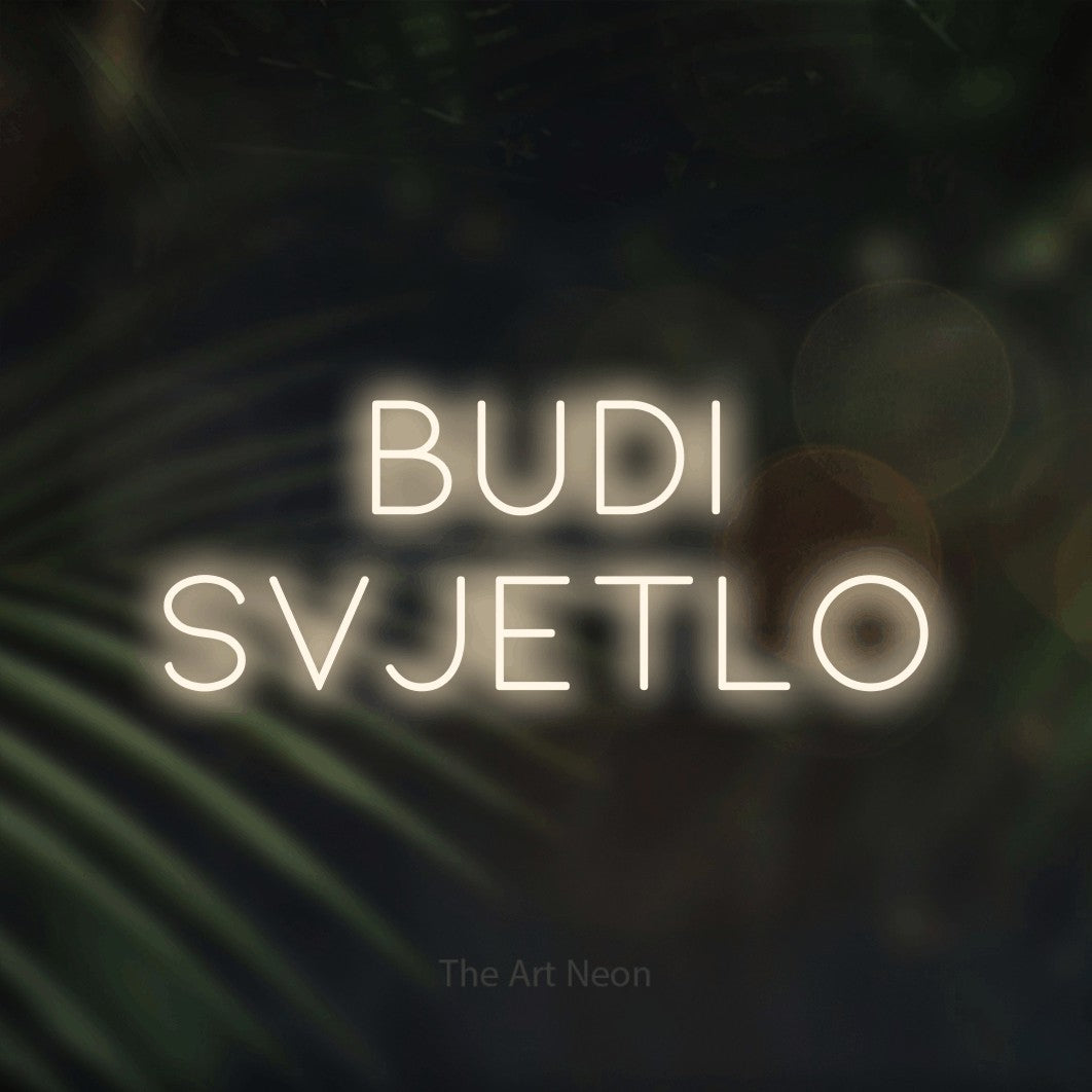 LED neon sign reading “budi svjetlo”, arranged in two lines.