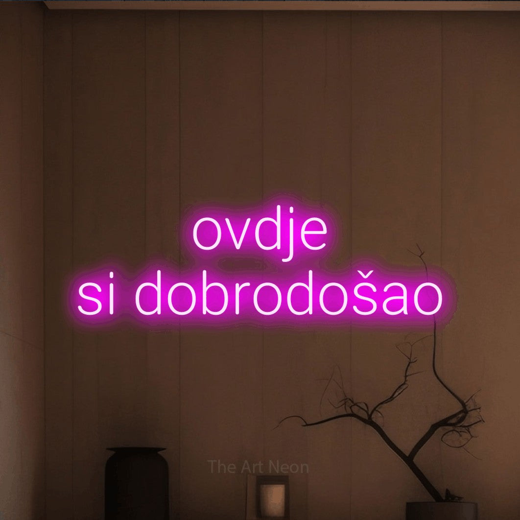 LED neon sign reading “ovdje si dobrodošao”, arranged in two lines.
