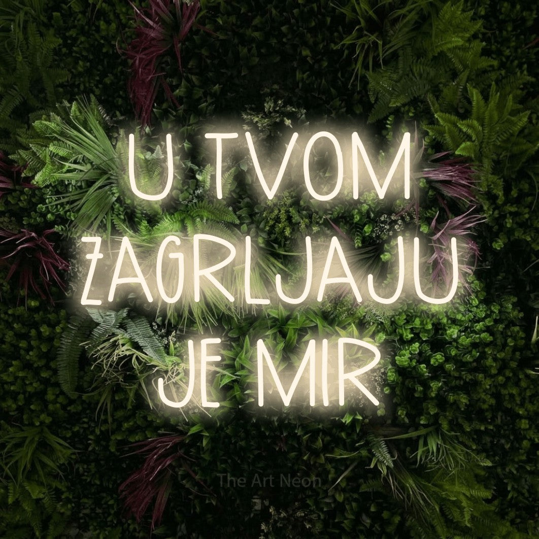 LED neon sign reading “U TVOM ZAGRLJAJU JE MIR”, arranged in three lines.