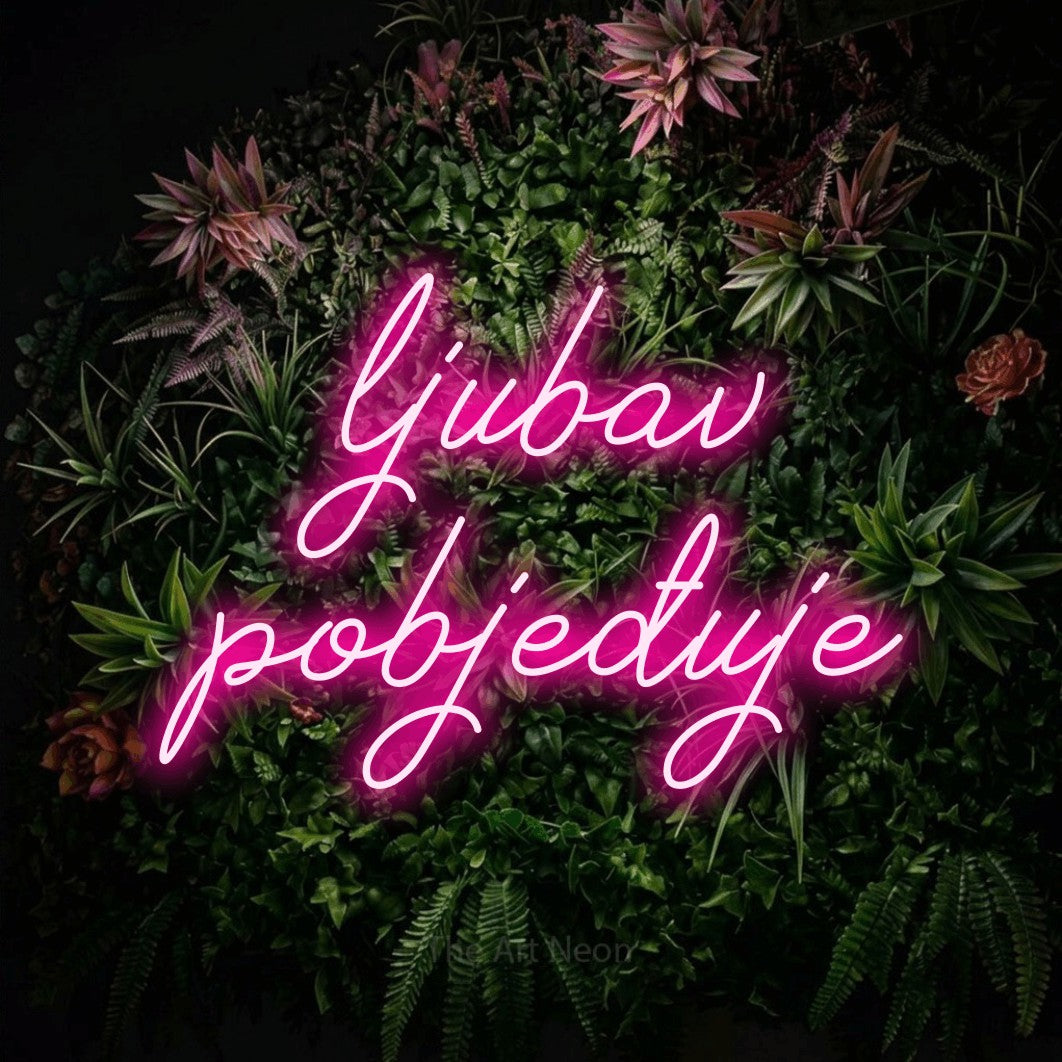 LED neon sign reading “ljubav pobjeđuje”, arranged in two lines.