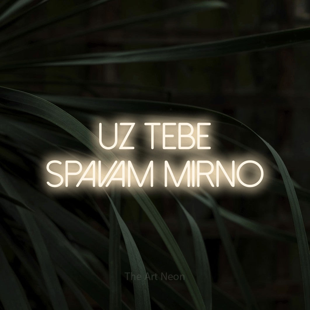 LED neon sign reading “UZ TEBE SPAVAM MIRNO”, arranged in two lines.