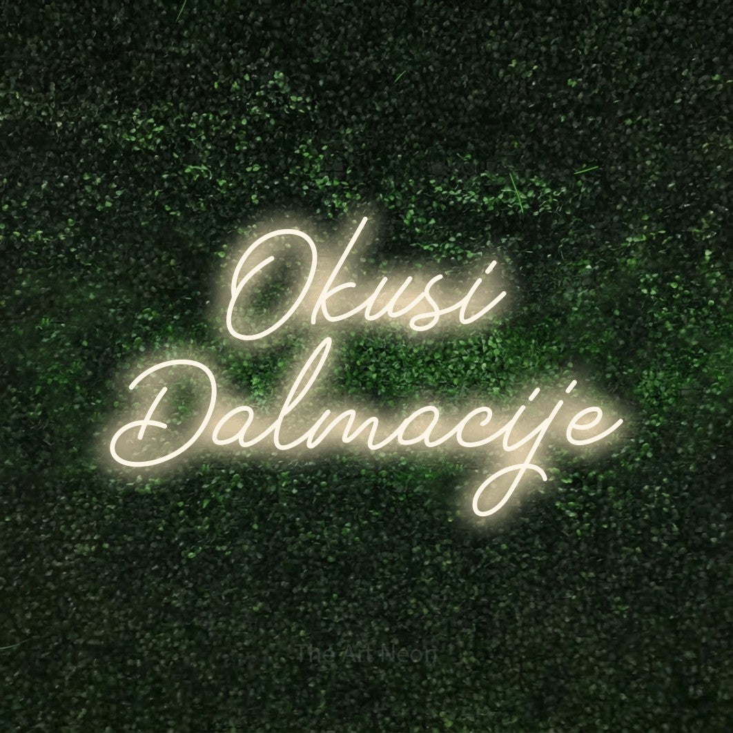 LED neon sign reading “Okusi Dalmacije”, arranged in two lines.