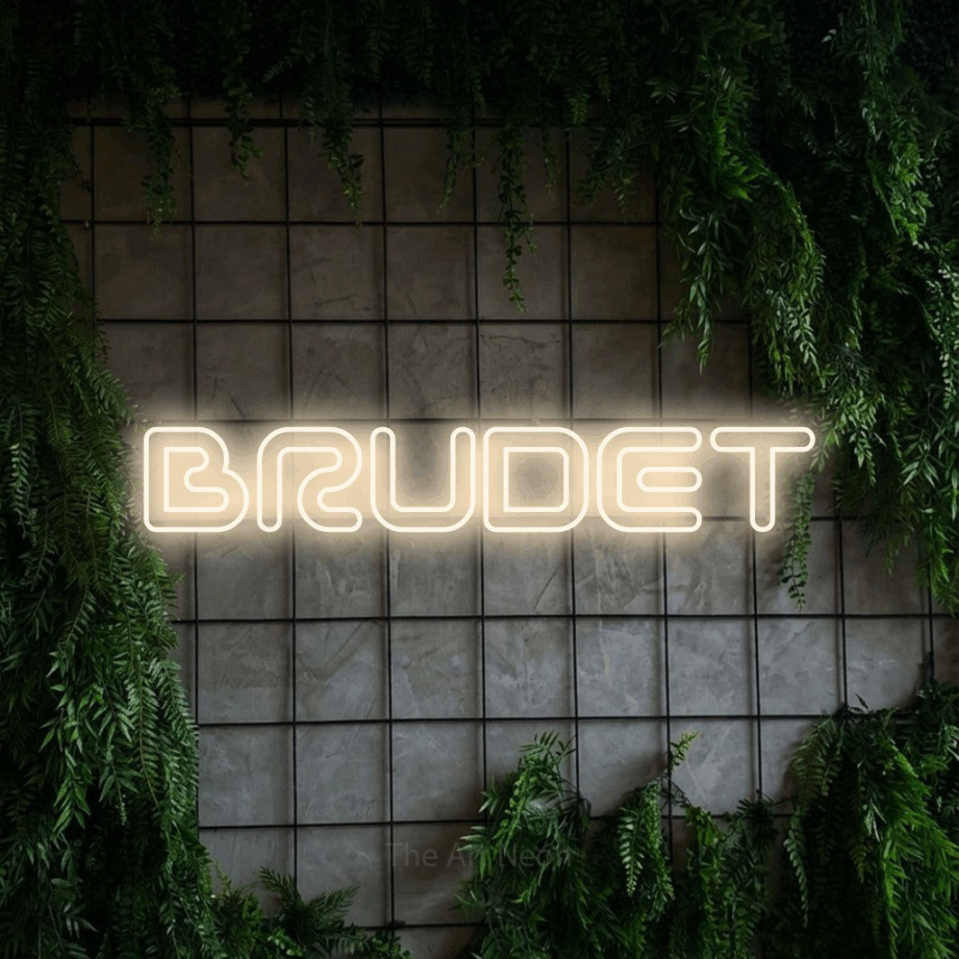 LED neon sign reading “BRUDET”, arranged in a single line.