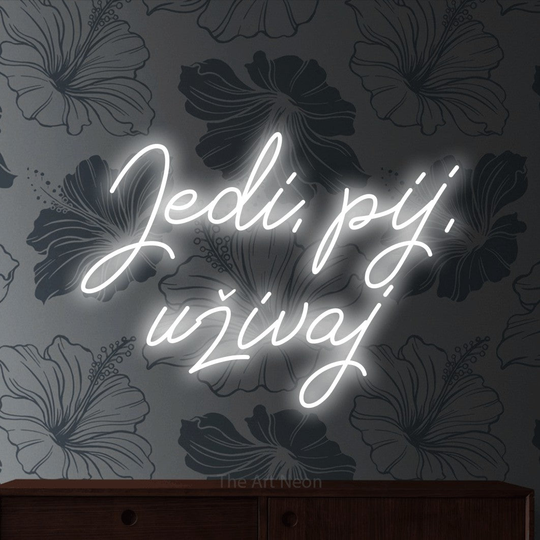 LED neon sign reading “Jedi, pij, uživaj”, arranged in two lines.