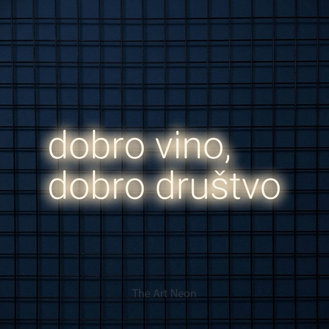 LED neon sign reading “dobro vino, dobro društvo”, arranged in two lines.