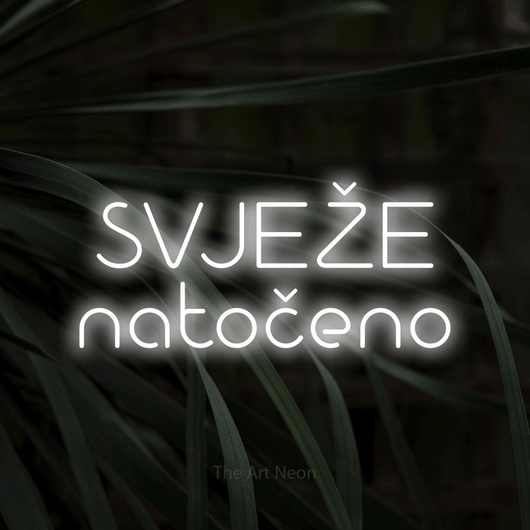 LED neon sign reading “SVJEŽE natočeno”, arranged in two lines.