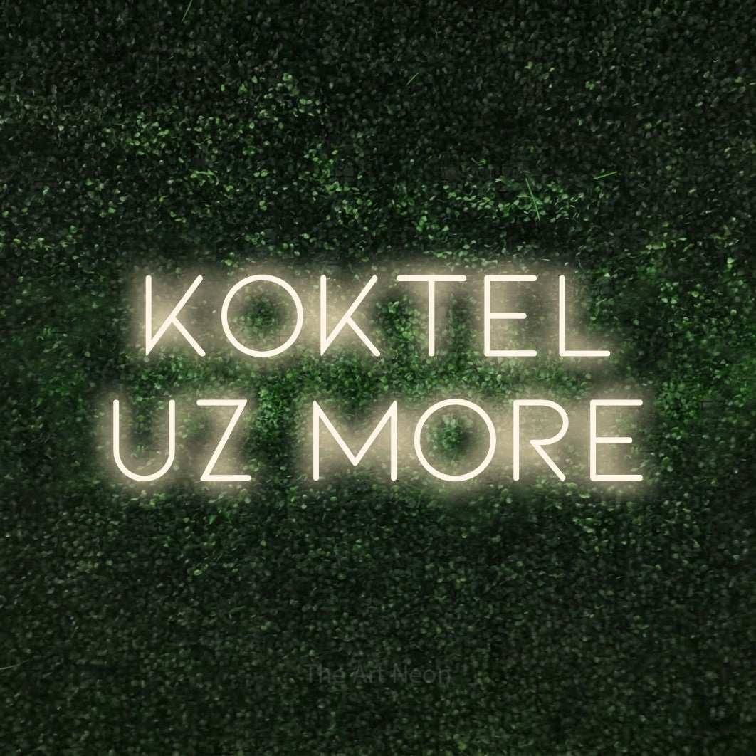 LED neon sign reading “koktel uz more”, arranged in two lines.