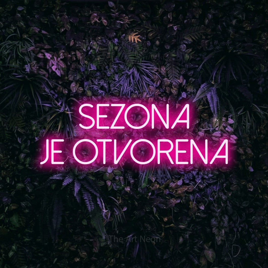 LED neon sign reading “SEZONA je otvorena”, arranged in two lines.