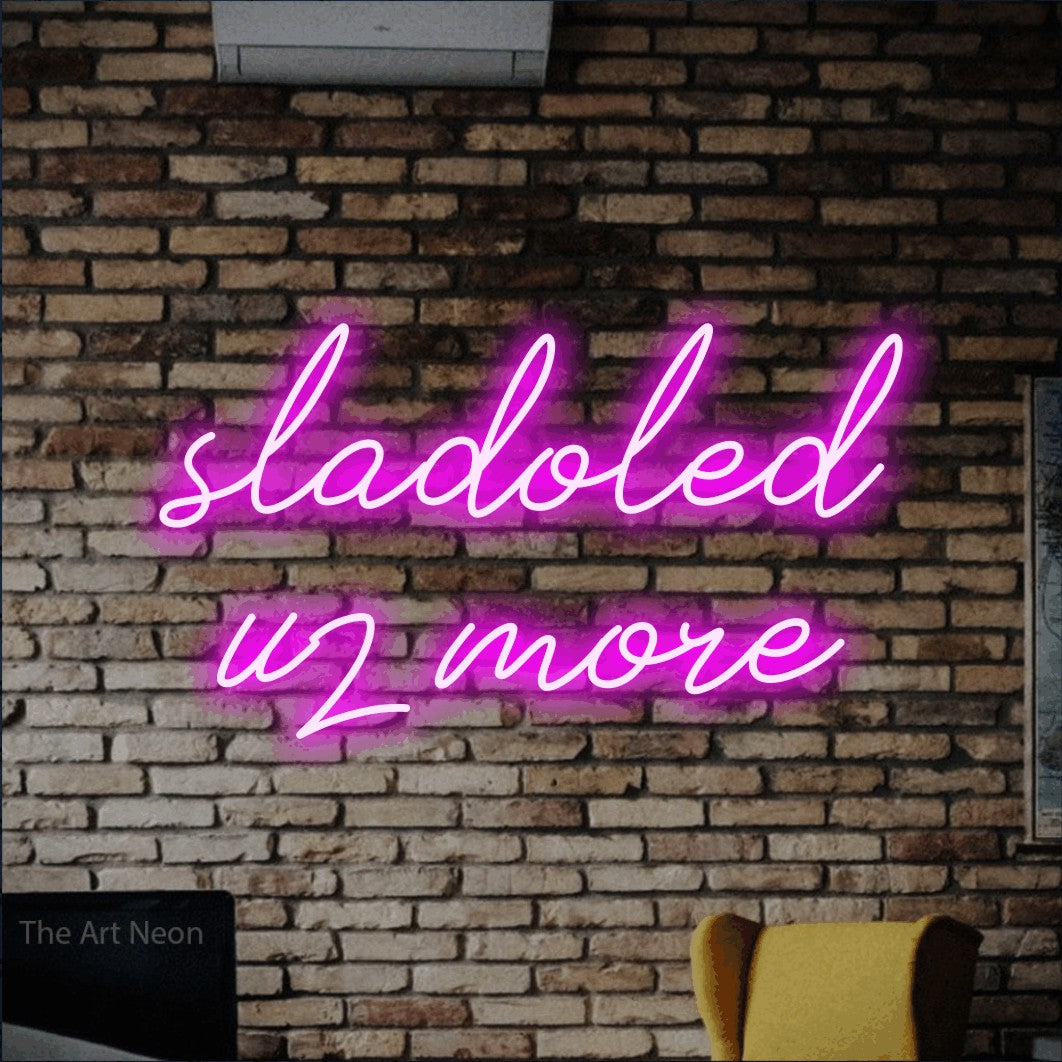 LED neon sign reading “sladoled uz more”, arranged in two lines.
