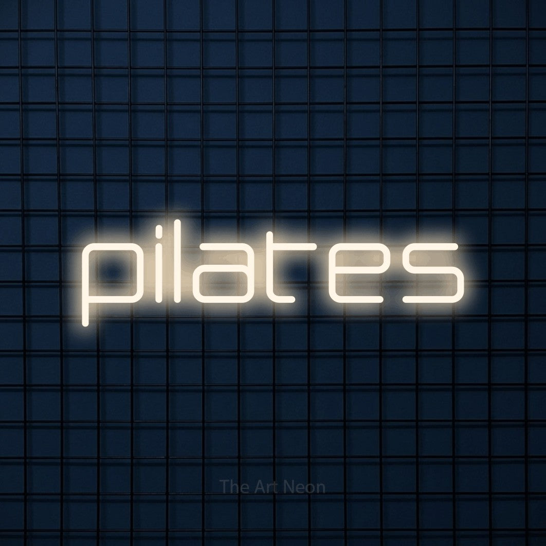LED neon sign reading “pilates”, arranged in a single line.