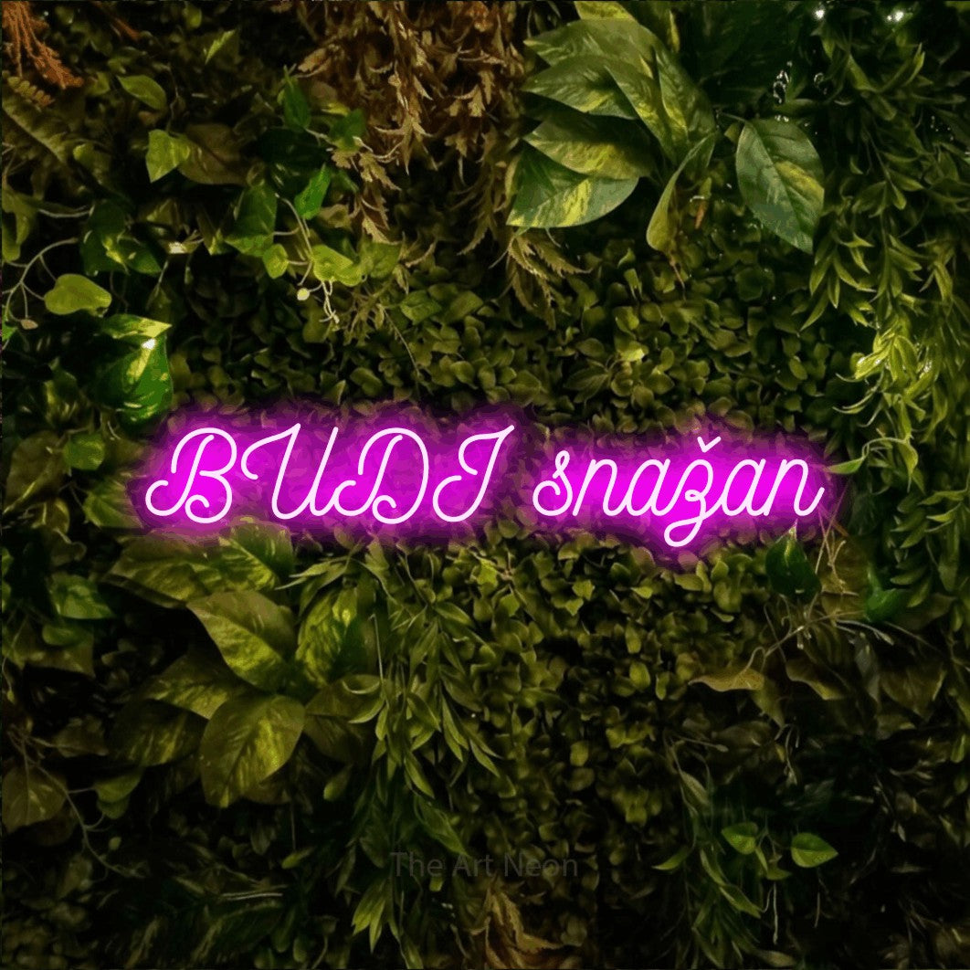 LED neon sign reading “BUDI snažan”, arranged in a single line.