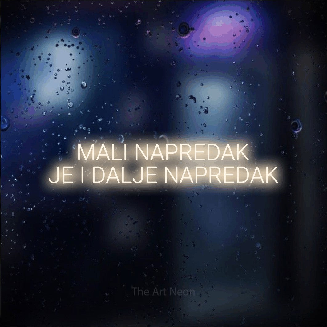 LED neon sign reading “MALI NAPREDAK JE I DALJE NAPREDAK”, arranged in two lines.