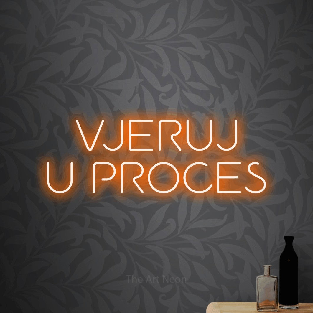 LED neon sign reading “VJERUJ U PROCES”, arranged in two lines.