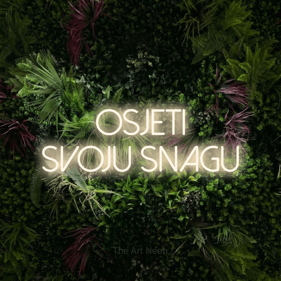 LED neon sign reading “osjeti svoju snagu”, arranged in two lines.