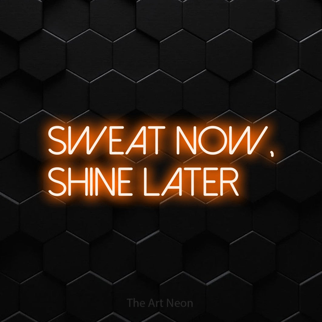 LED neon sign reading “Sweat Now, Shine Later”, arranged in two lines.