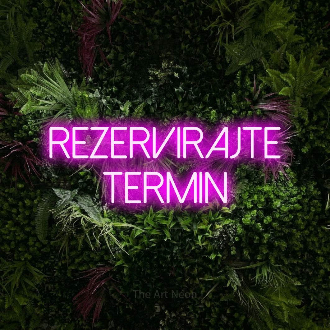 LED neon sign reading “REZERVIRAJTE termin”, arranged in two lines.