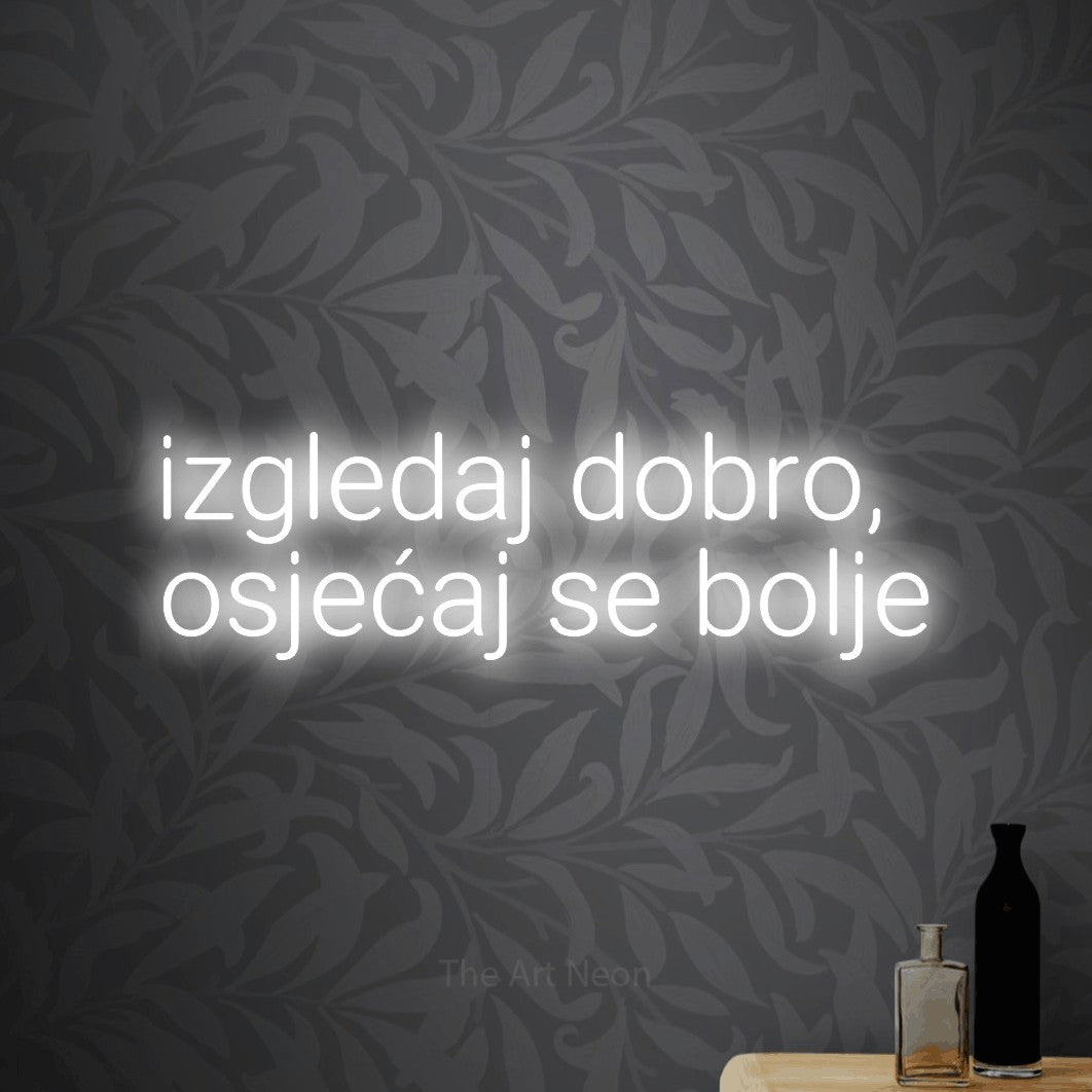 LED neon sign reading “izgledaj dobro, osjećaj se bolje”, arranged in two lines.
