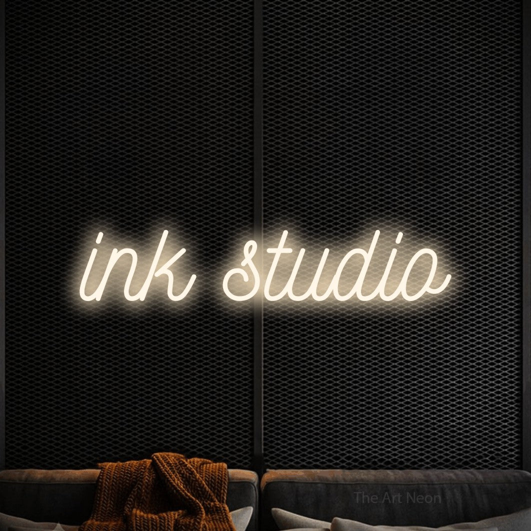 LED neon sign reading “ink studio”, arranged in a single line.