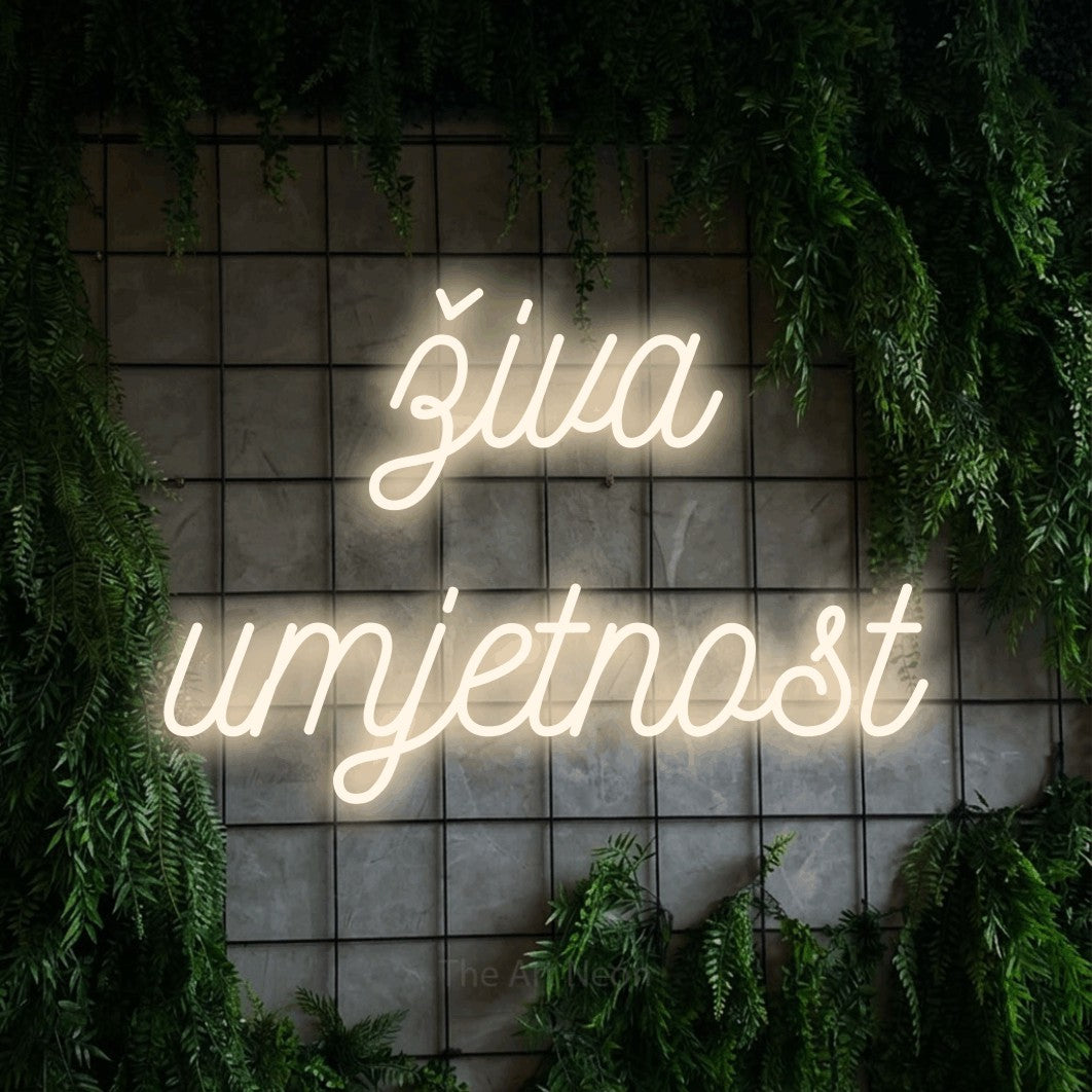 LED neon sign reading “živa umjetnost”, arranged in two lines.